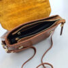 Sac à main Bauletto en cuir marron avec poignée unique et longue sangle